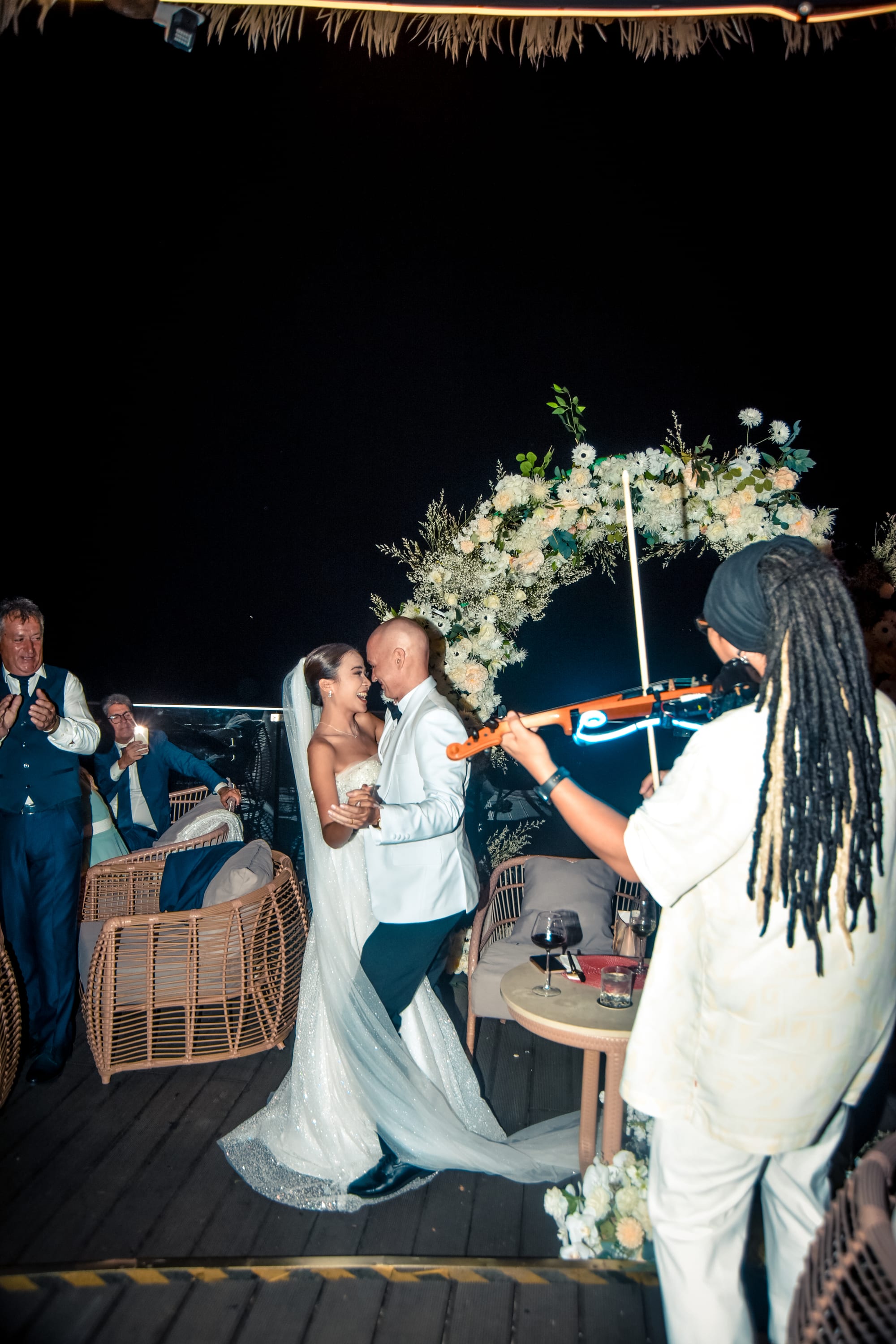 First dance under the floral arch at a Tree Bay Clubhouse wedding