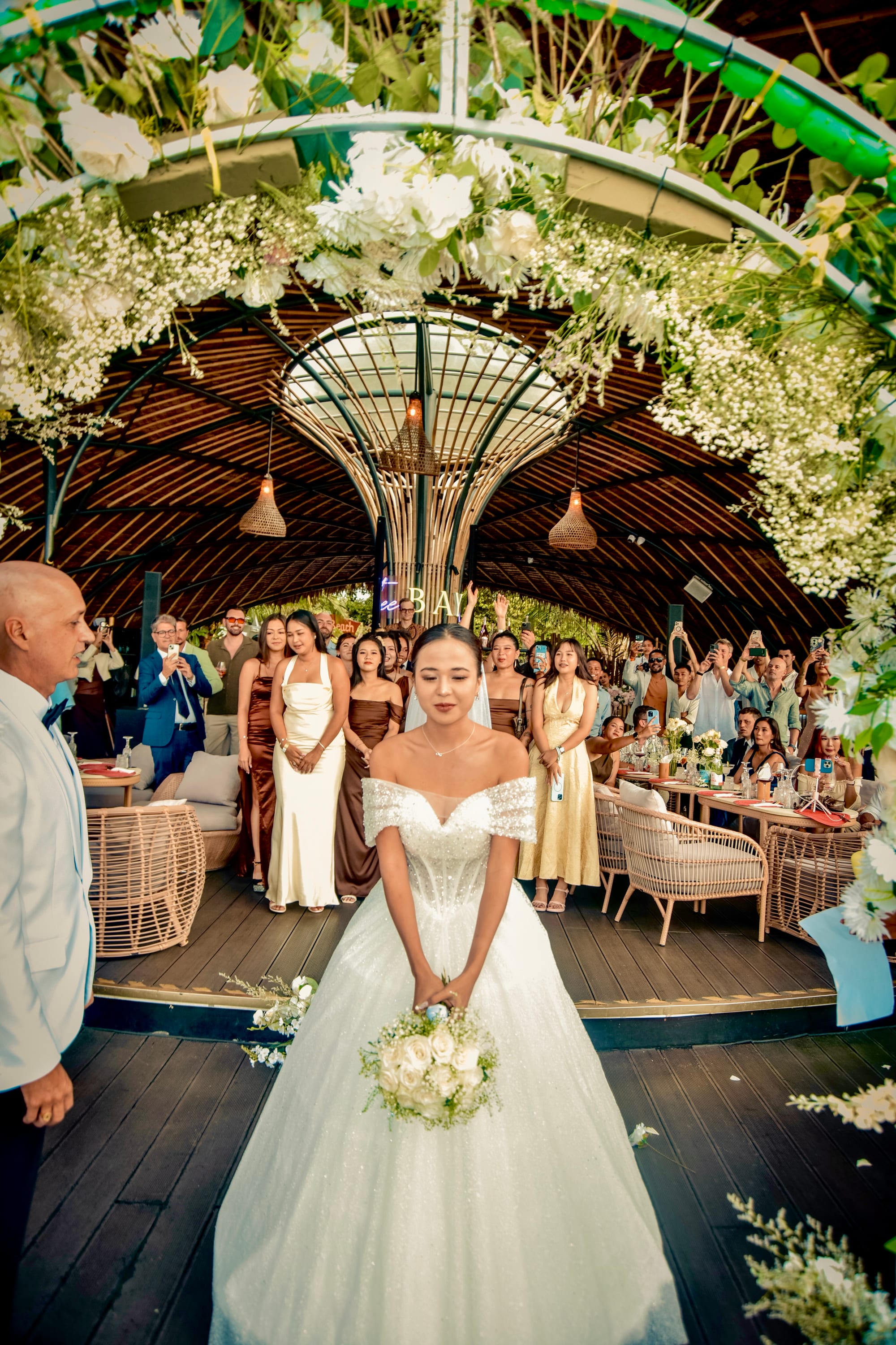 Bride walking down the aisle under the domed terrace at Tree Bay Clubhouse